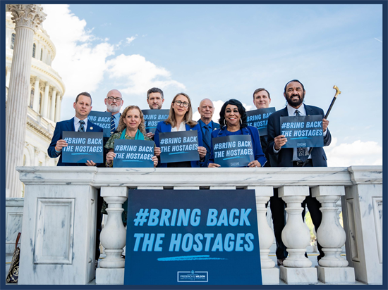 Rep. Scholten poses with colleagues in blue